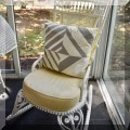 F29. White wicker rocking chair. 